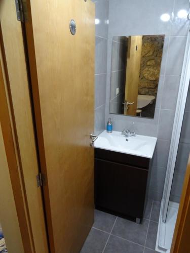 a bathroom with a sink and a mirror at Refúgio Rural no Gerês - Casa Araujo de Sousa in Terras de Bouro