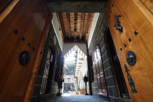 an empty hallway in a building with a chandelier at The Green Park Diyarbakir in Diyarbakır