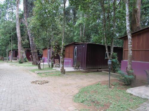 a group of buildings with trees and a parking meter at Lawu Forest Camp in Sarangan
