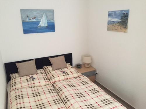 a bedroom with two beds and a sailboat on the wall at Altstadt-Ferienwohnung in Tangermünde