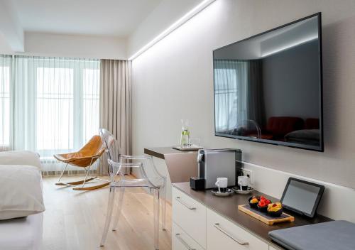 a living room with a large flat screen tv on a wall at Boutique Hotel Hauser in Wels