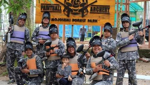 a group of people in military uniforms posing for a picture at Lawu Forest Camp in Sarangan