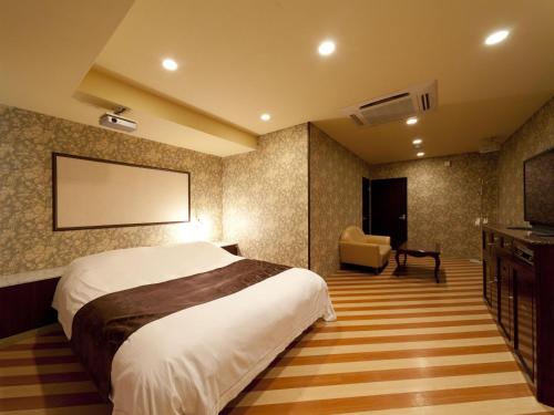 Posteľ alebo postele v izbe v ubytovaní Hotel Fine Garden Matsuzaka III