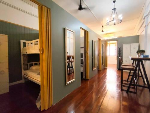 a hallway with a bedroom and a bunk bed at Hub Hostel Hatyai in Hat Yai