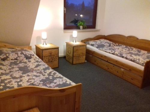 a room with two beds and two tables with candles on them at Ferienwohnung, Monteurwohnung bis 6 Personen in Rottorf