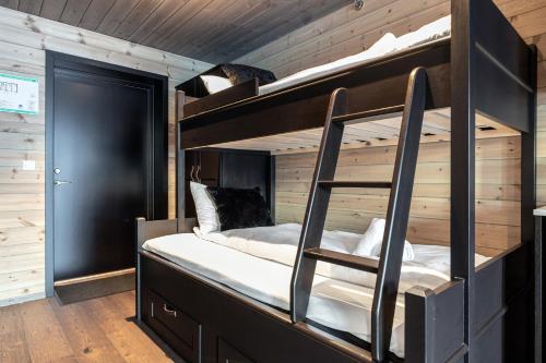 a bedroom with two bunk beds in a cabin at Skigaarden in Hemsedal