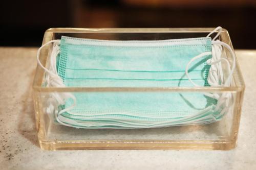 a plastic container with a pair of surgical masks at Lawu Forest Camp in Sarangan