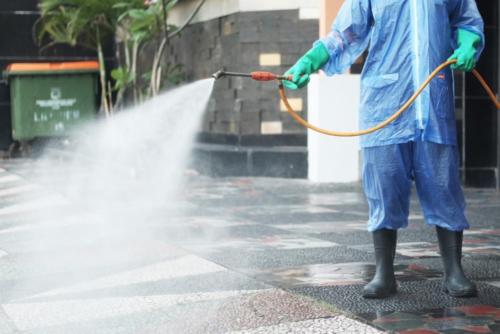 a man with a hose and a water hose at Lawu Forest Camp in Sarangan
