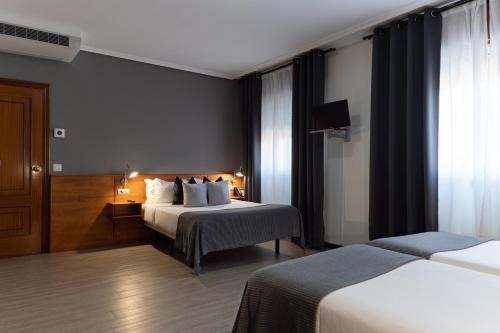 Кровать или кровати в номере Hotel Carlos 96