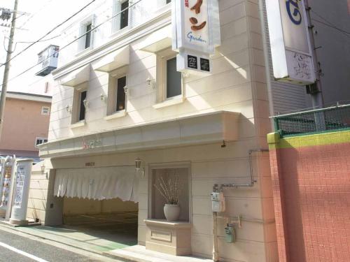 a building with a potted plant on the side of it at Hotel Fine Garden Sakai in Sakai