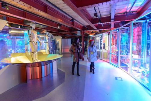 two people are standing in a room with glass windows at Manchester Portland By Sunday in Manchester