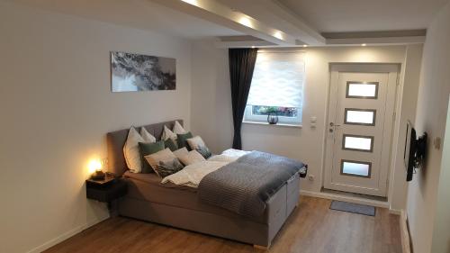 a bedroom with a bed and a window and a door at Apartment Airport Cologne in Cologne