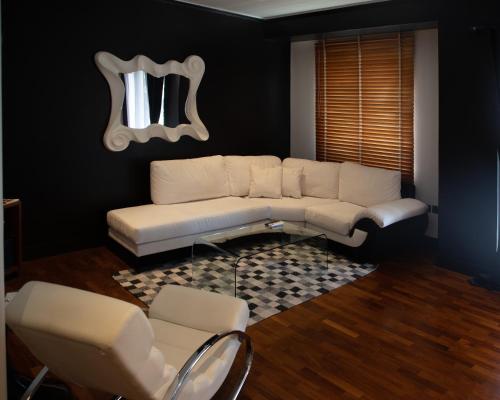 a living room with a couch and a table at Andromeda Suites in Athens