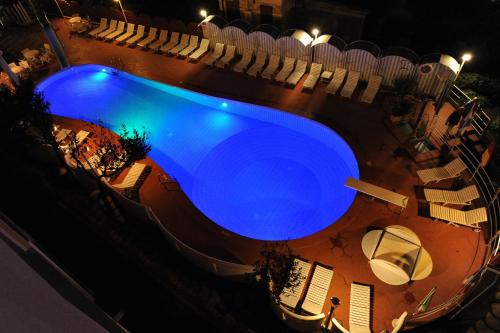 an overhead view of a swimming pool at night at Hotel Rosalba - Valentini Family Village in Bellaria-Igea Marina