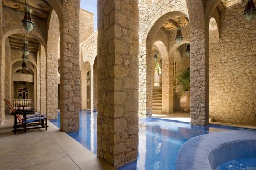 a courtyard with a hot tub in a building at La Sultana Oualidia in Oualidia