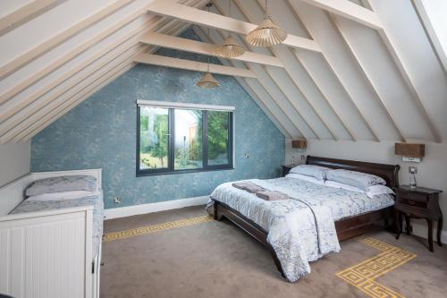 a bedroom with a large bed and a window at Guildford Manor Hotel & Spa in Guildford