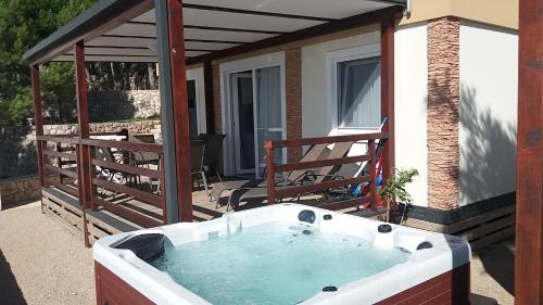 a hot tub on the patio of a house at Lavanda Mobile Homes & Villas in Orebić