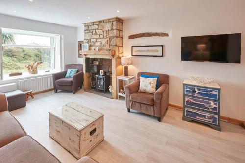 a living room with a couch and chairs and a fireplace at Host & Stay - The Cottage, Marske in Marske-by-the-Sea