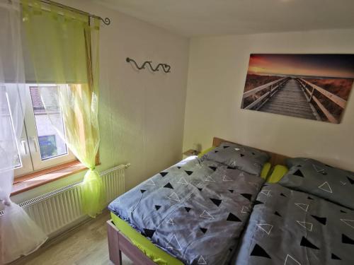 a bedroom with a bed and a window at FeWoQuido 1 in Königsee