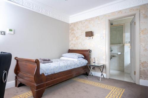 a bedroom with a bed and a walk in shower at Guildford Manor Hotel & Spa in Guildford