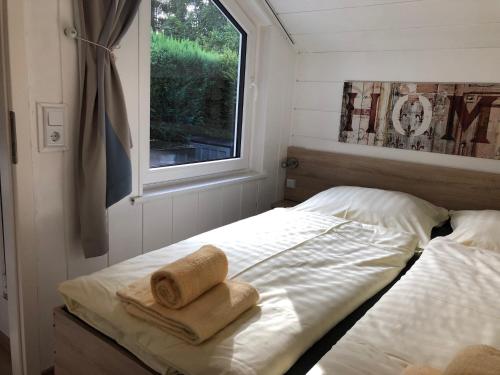 a small bedroom with a bed with towels on it at Apartment Happy Holiday in Winterberg