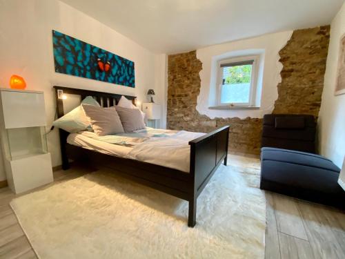 A bed or beds in a room at Eifelstein, Apartment mit Whirlpool und Ofen