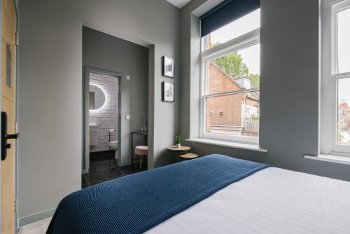 a bedroom with a bed and two windows at CitySpace Tower Bridge in London