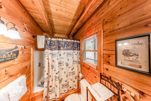 a dining room with wood paneling and a window at Beary Comfy in Gatlinburg