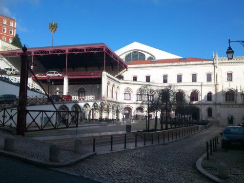 a city street with a bridge in front of a building at Pensao Estacao Central in Lisbon