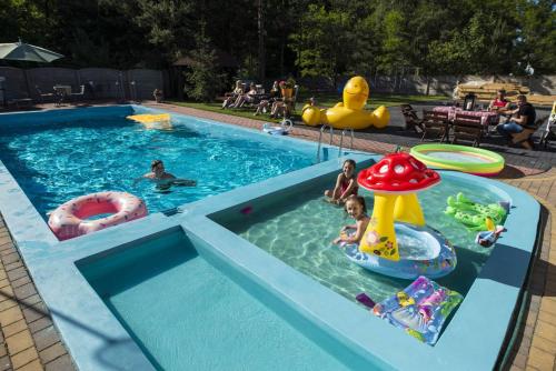 a pool with people playing in the water at Jurajskie Apartamenty in Żarki