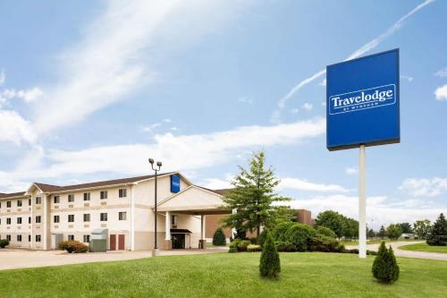 a blue and white building with a sign on top of it at Travelodge by Wyndham Clinton Valley West Court in Clinton