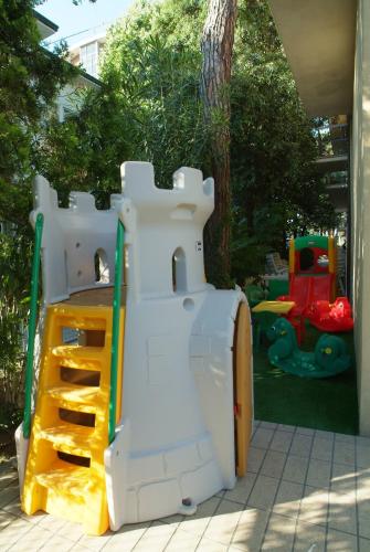 a childs playground with a toy train in a yard at Hotel Maré - Valentini Family Village in Bellaria-Igea Marina
