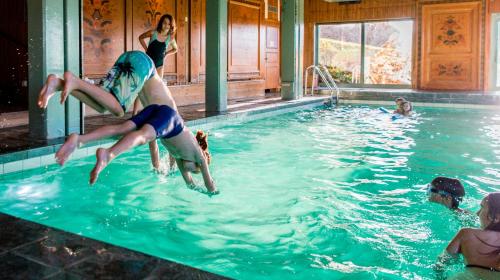 a group of people playing in a swimming pool at Green Hotel in Tällberg