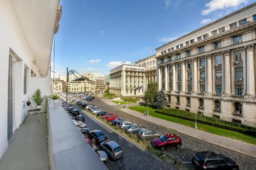a view of a street with cars parked in a parking lot at SIMPLE YET STYLISH. Piata Revolutiei Apartment in Bucharest