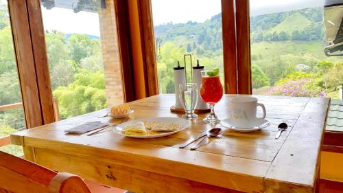 a wooden table with food and drinks on top of a window at Rancho San Antonio in Salento