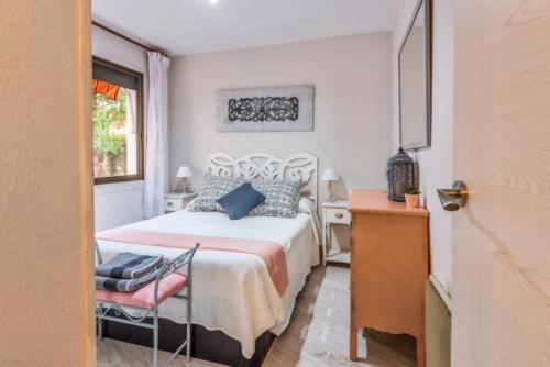 - une chambre avec un lit, une chaise et une fenêtre dans l'établissement Apartamentos Bellamar, à Cambrils