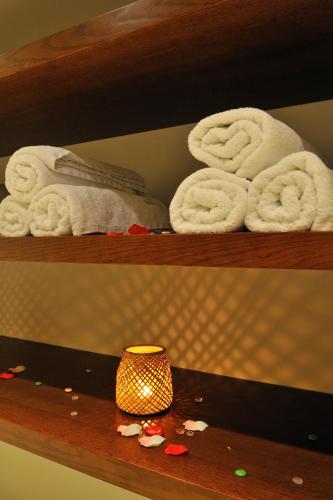 two shelves with towels and a lamp on a table at Egnatia City Hotel & Spa in Kavala