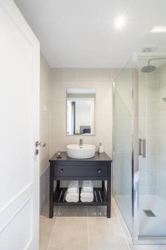 a bathroom with a sink and a shower at Casa da Veiga in Aldeia