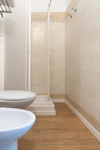 a bathroom with two toilets and a shower at Fox House BnB in LʼAquila
