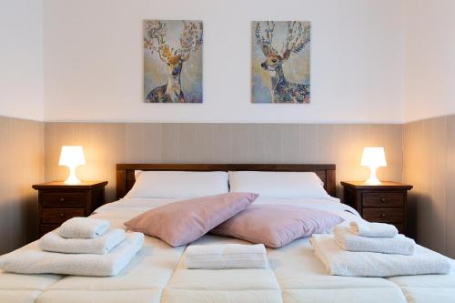 a bedroom with a bed with two pillows on it at Fox House BnB in LʼAquila
