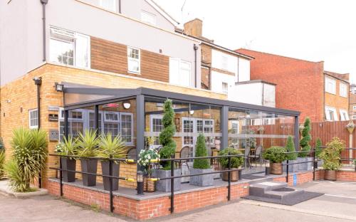 a building with plants inside of it at Imperial Guest House Ltd. in Hounslow