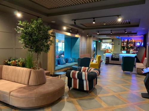 a lobby with couches and chairs and a living room at Hotel Urban in Plovdiv