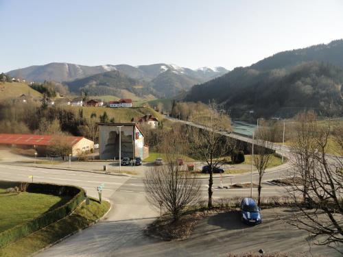 a street with a car on a road with mountains at Ennstalerhof in Grossraming