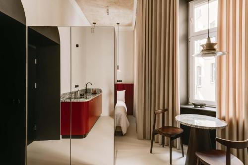a bathroom with a sink and a table in a room at Stylish apartment close to Wawel, Old Town Studio, Main Sq. 3 min in Kraków