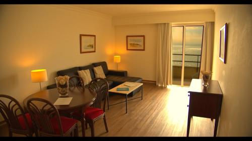 a living room with a couch and a table at Hotel Solar Palmeiras in Paço de Arcos