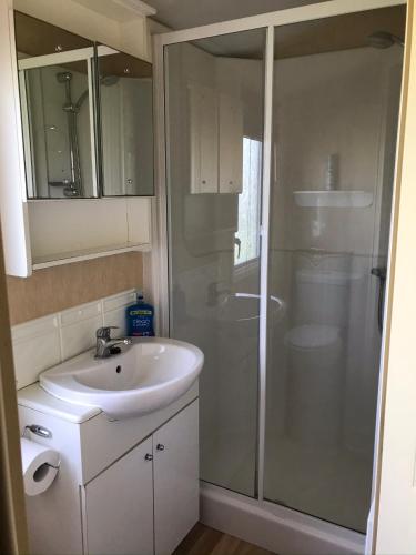 a bathroom with a sink and a shower at Happy Days Holidays in Flamborough