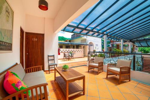 a patio with a couch and chairs and a table at Hotel Villa del Mar Tradicional in Puerto Vallarta