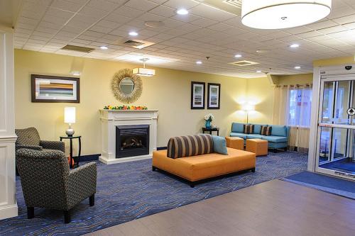 a lobby with couches and a fire place at Holiday Inn Express - Ludlow - Chicopee Area by IHG in Ludlow