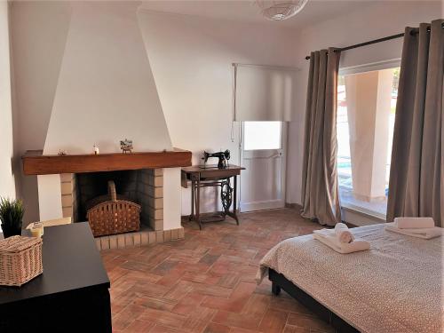 a bedroom with a bed and a fireplace at Moradia Pinhal da Telha in Corroios