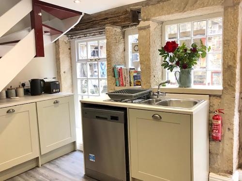 a kitchen with a sink and a counter top at Ewood Cottage *NEW* Exquisite Country Cottage in Todmorden